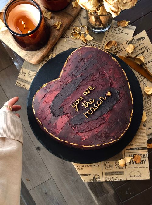 Free A heart-shaped cake with 'you are the reason' on a tray, perfect for celebrations. Stock Photo
