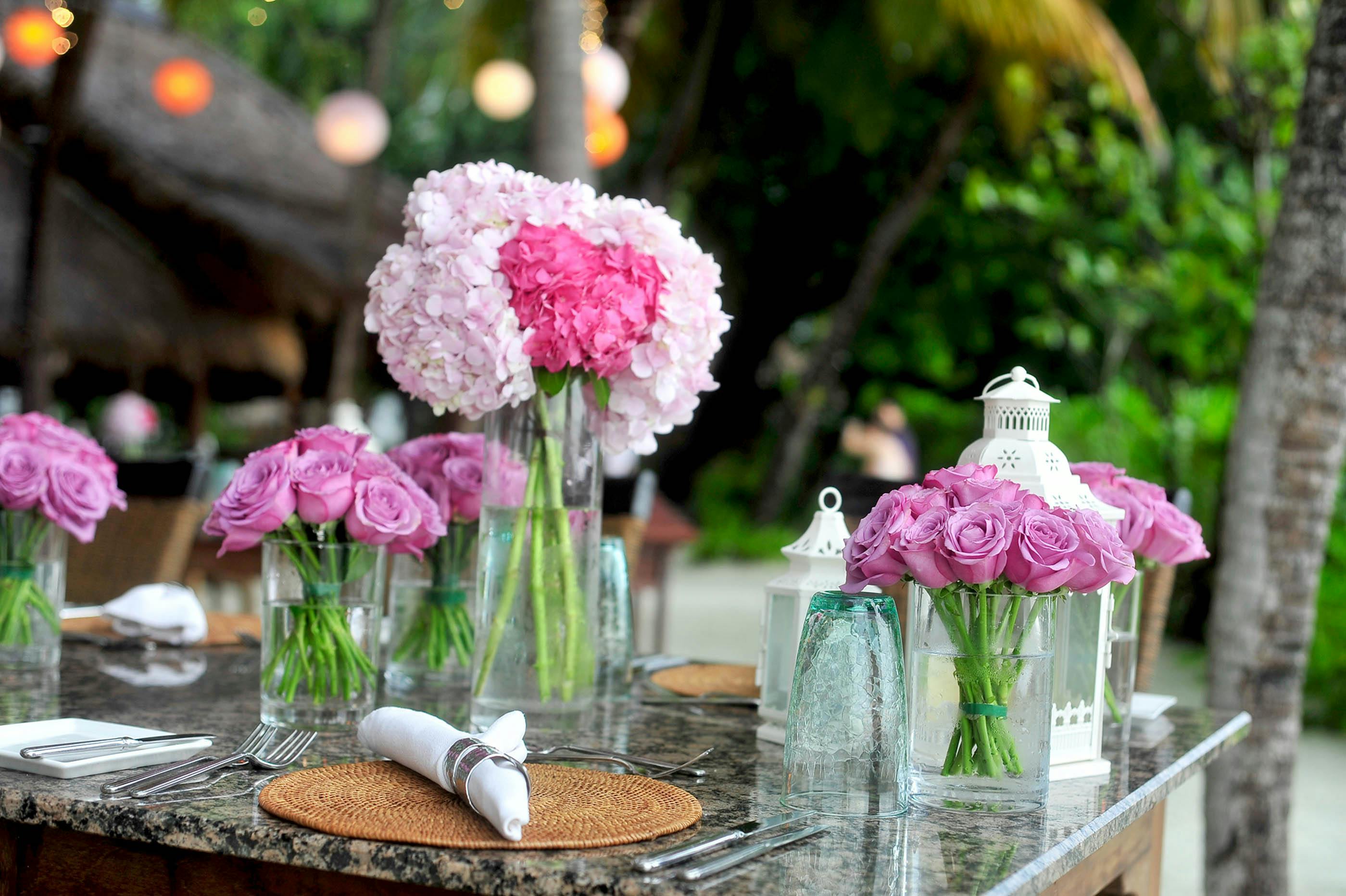 pink roses in clear glass vases