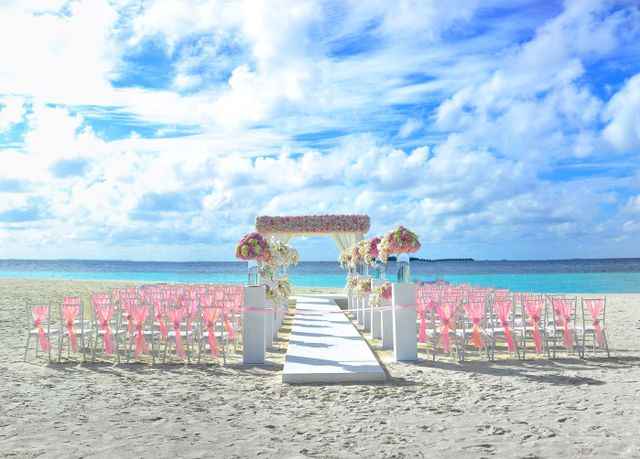 Wedding reception tables with white linens and floral centerpieces