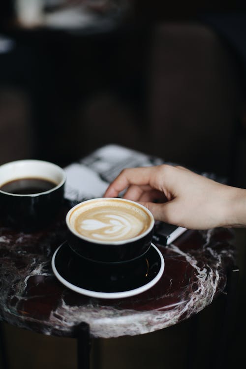 Free Person Holding A Cup Of Cappuccino Stock Photo