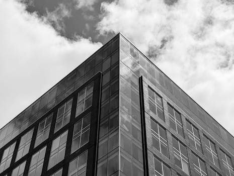 Black and white photo of a modern office building in Halifax with a cloudy sky.