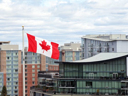 Canadian Flag Waving over City