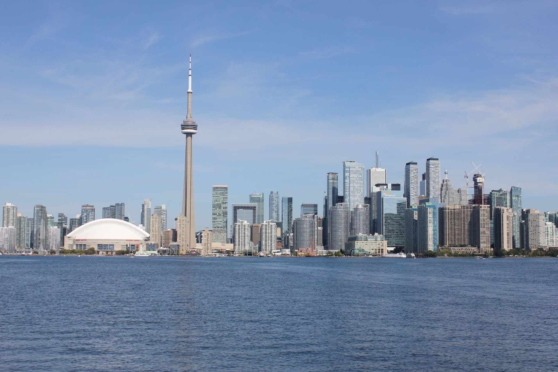 Stunning view of the Toronto skyline featuring the iconic CN Tower by Lake Ontario.