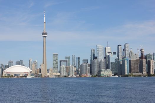 The iconic Toronto skyline featuring the CN Tower and modern skyscrapers by the waterfront.