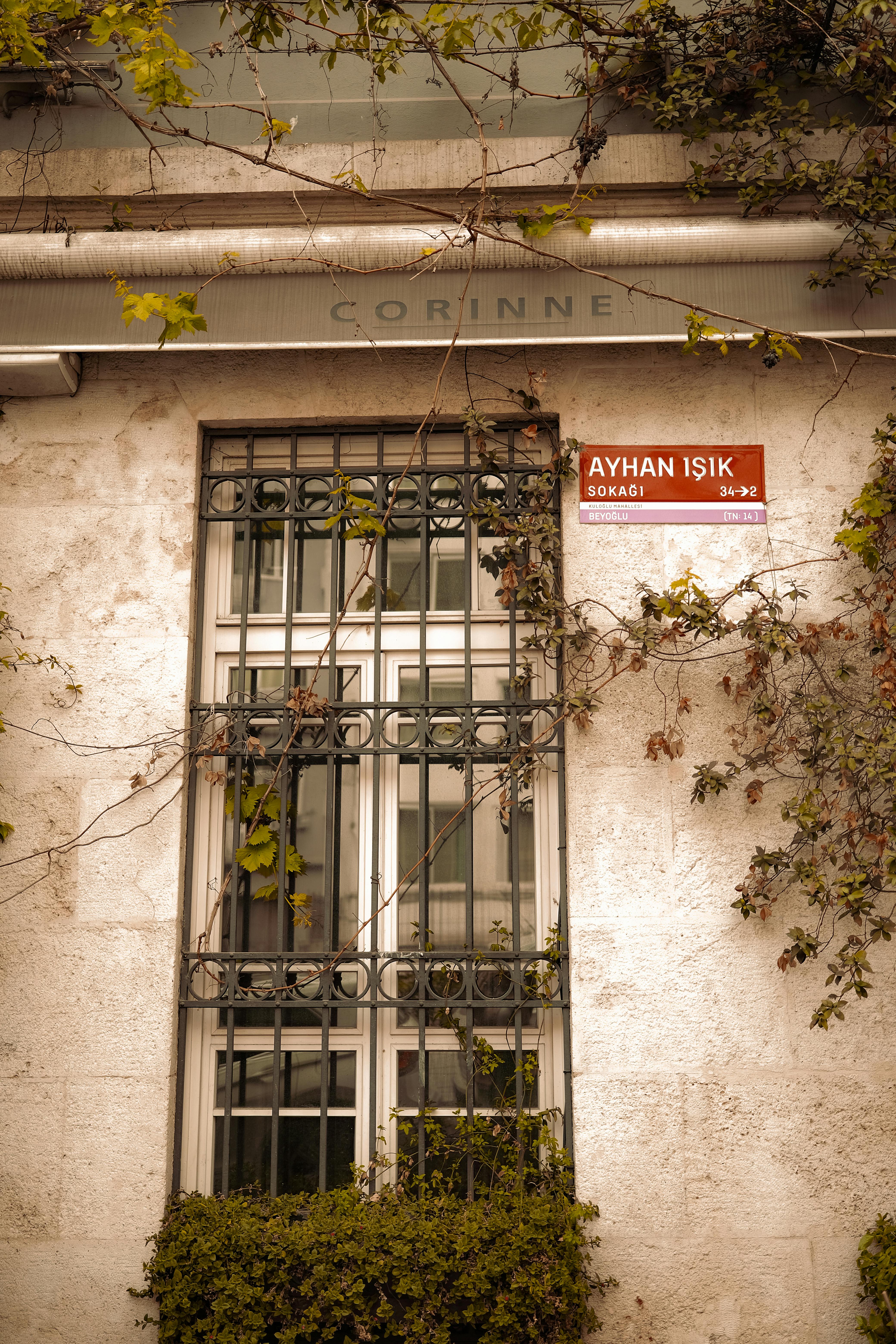 A detailed view of a window with iron grille on Ayhan Işık Street in a Turkish town.