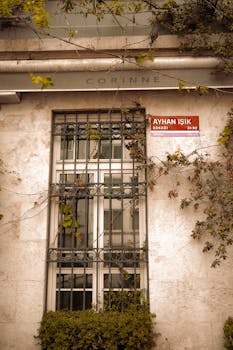 A detailed view of a window with iron grille on Ayhan Işık Street in a Turkish town.