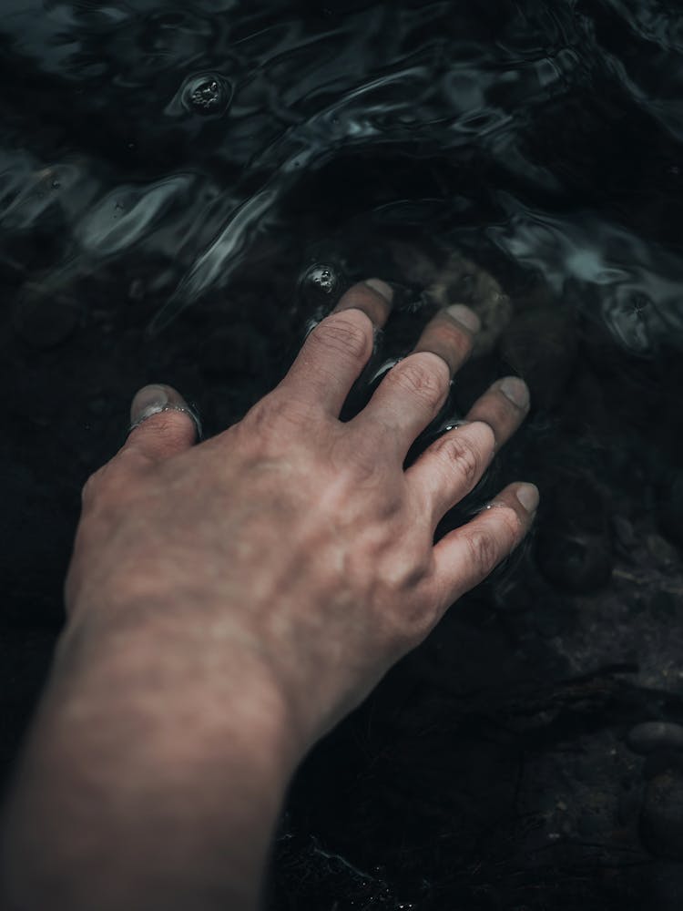 Hand Touching Water