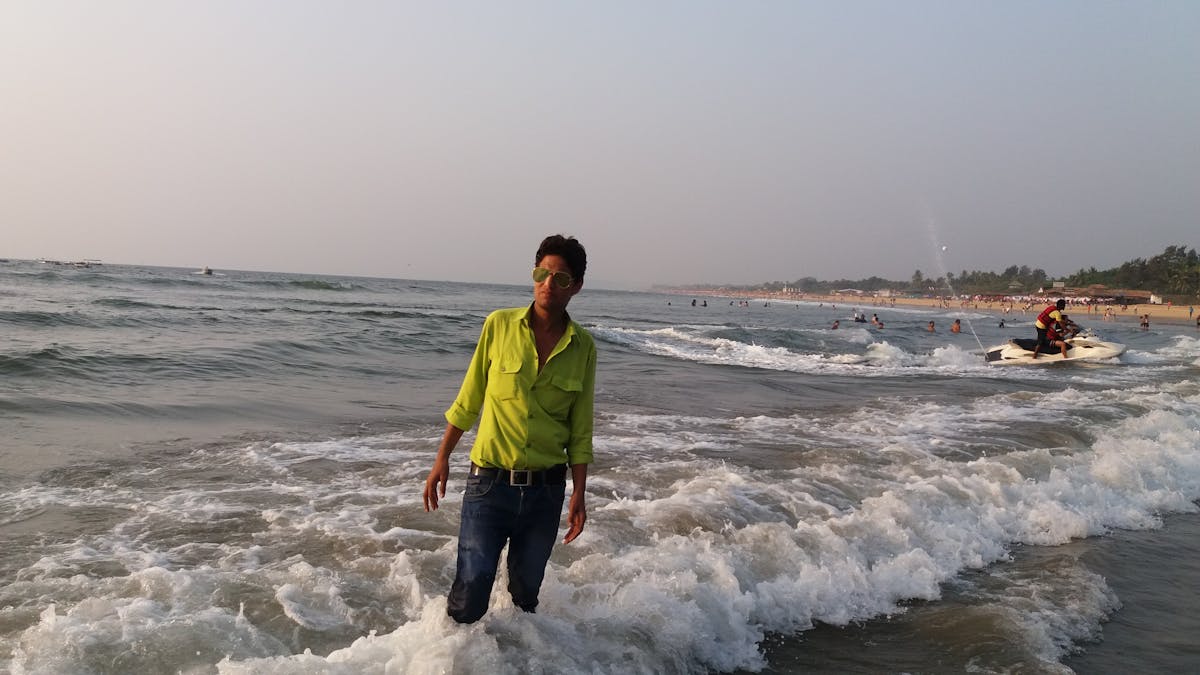 Destination wedding couple standing on a cliff overlooking the sea