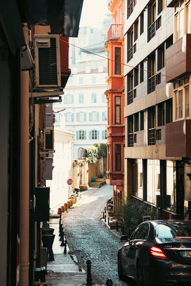 Car On Narrow Street In Town