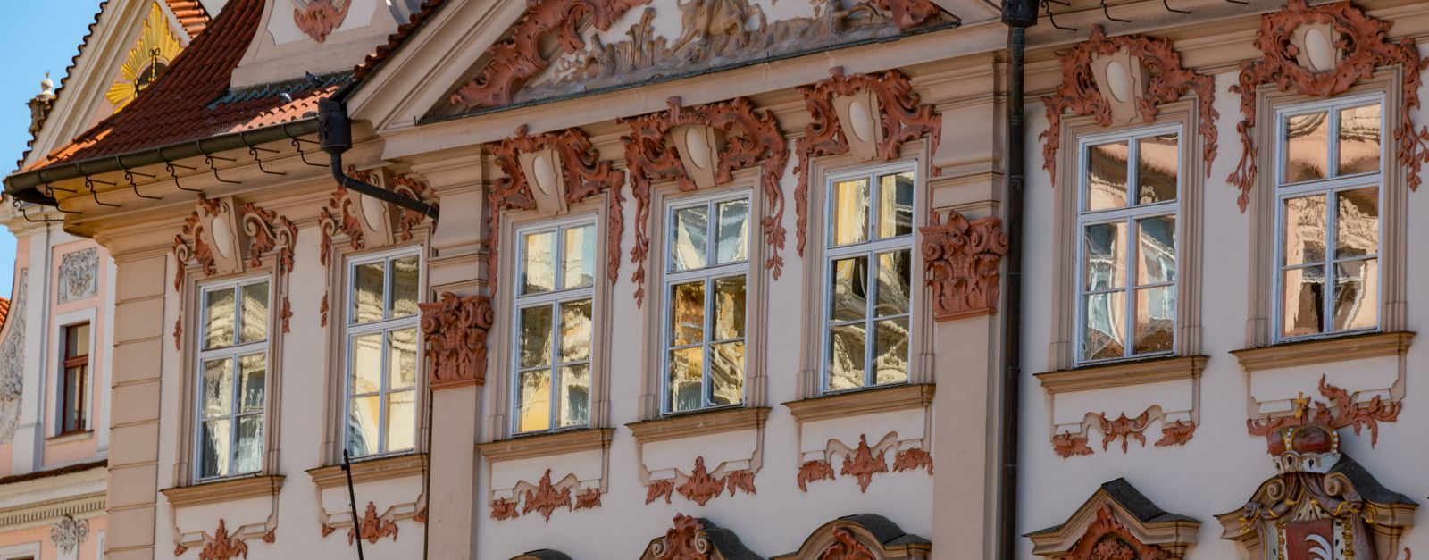 Elegant Baroque building facade in Prague, showcasing intricate design elements.