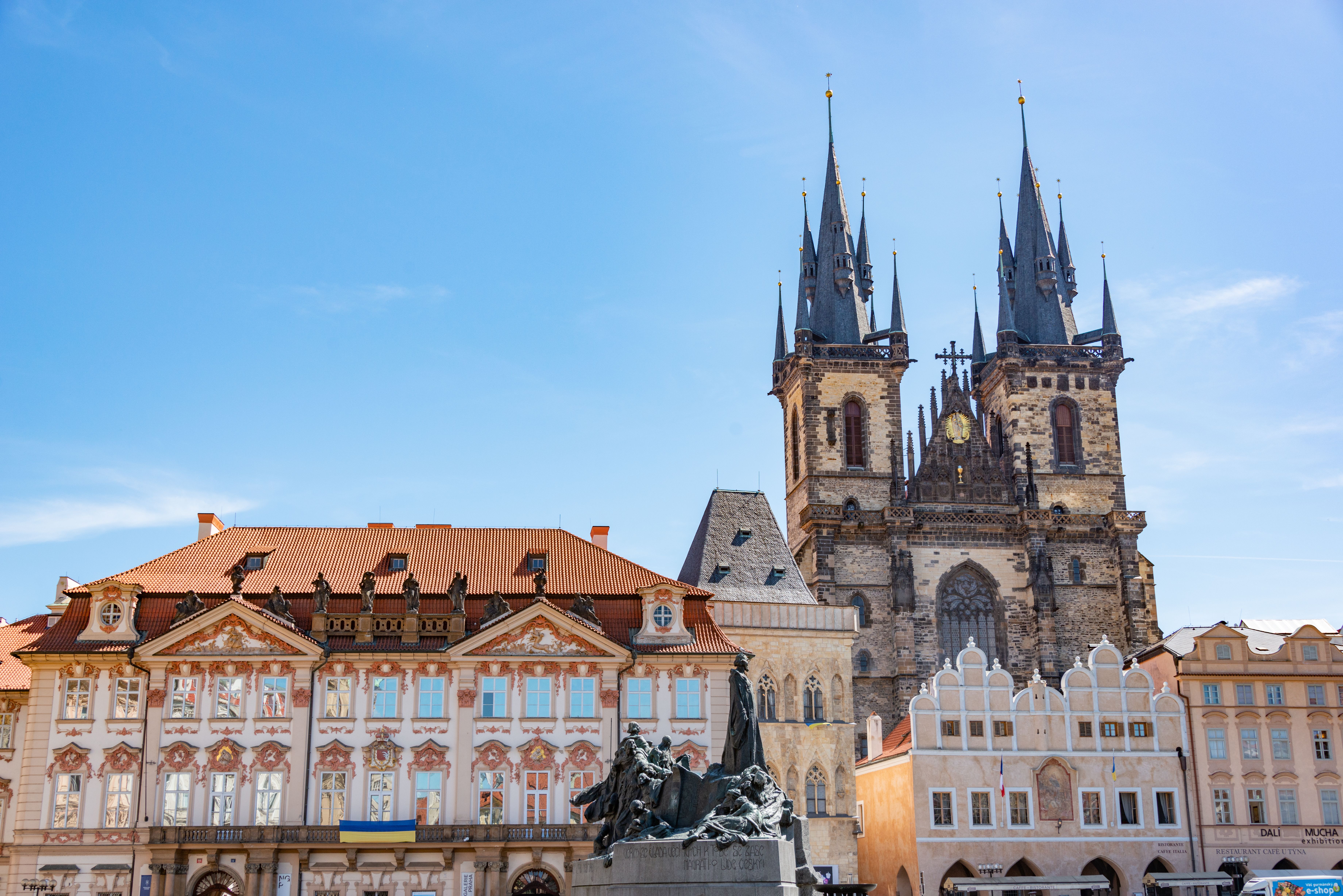 Explore the iconic Gothic architecture of the Church of Our Lady Before Tyn against a clear Prague sky.