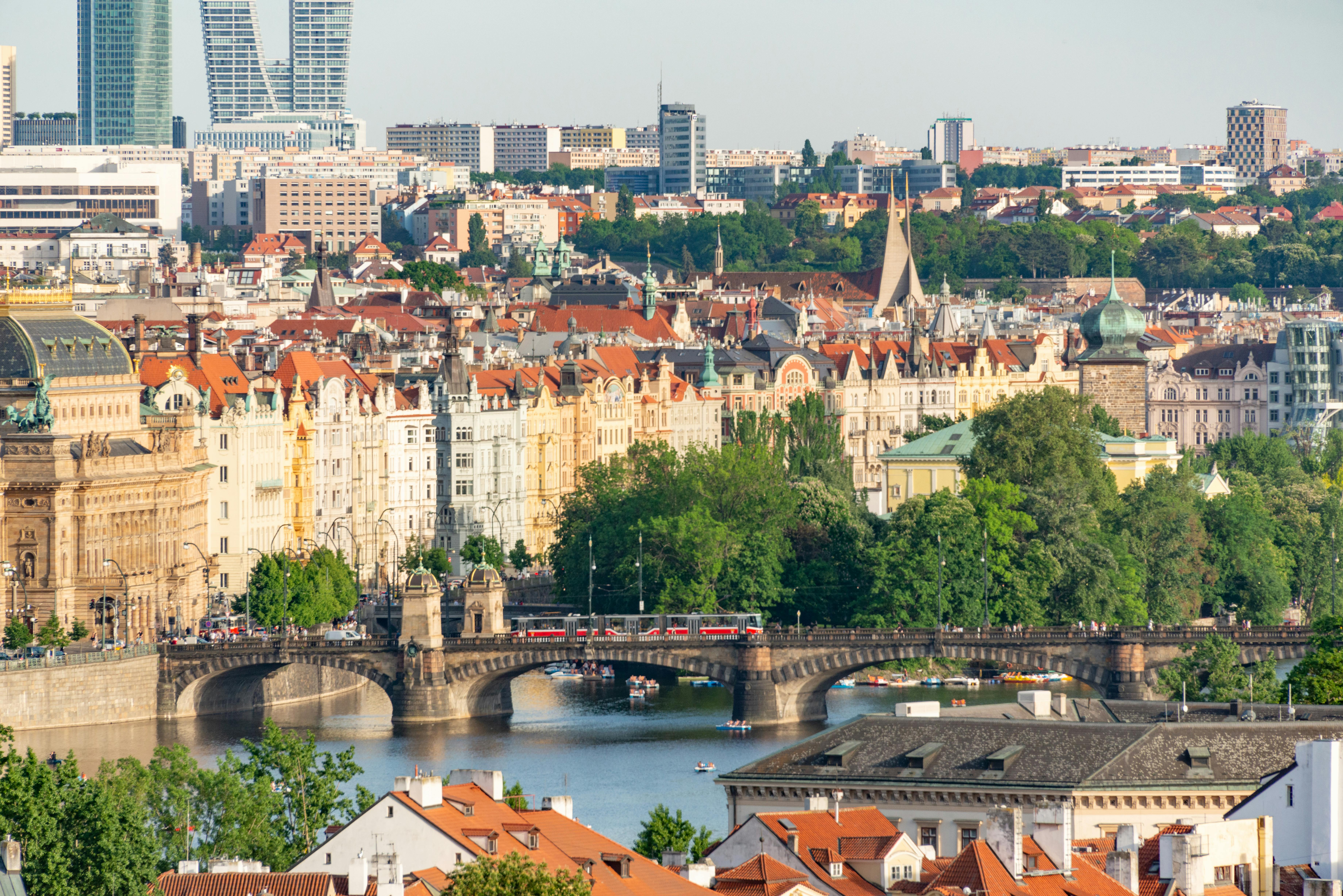 Aerial view of Charles Bridge and Prague's historic rooftops from above