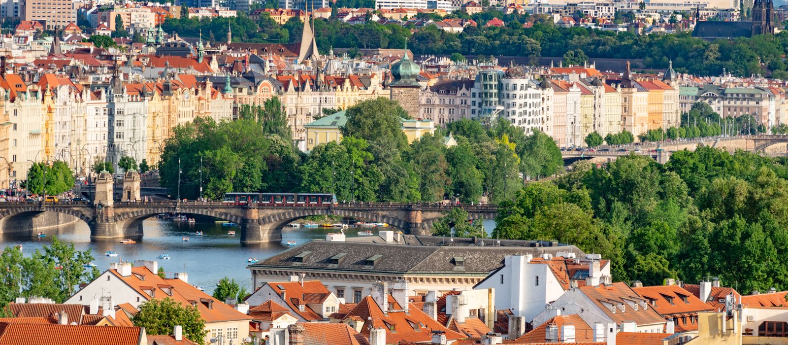 Explore the historic charm of Prague's bridges and architecture with this stunning aerial cityscape.