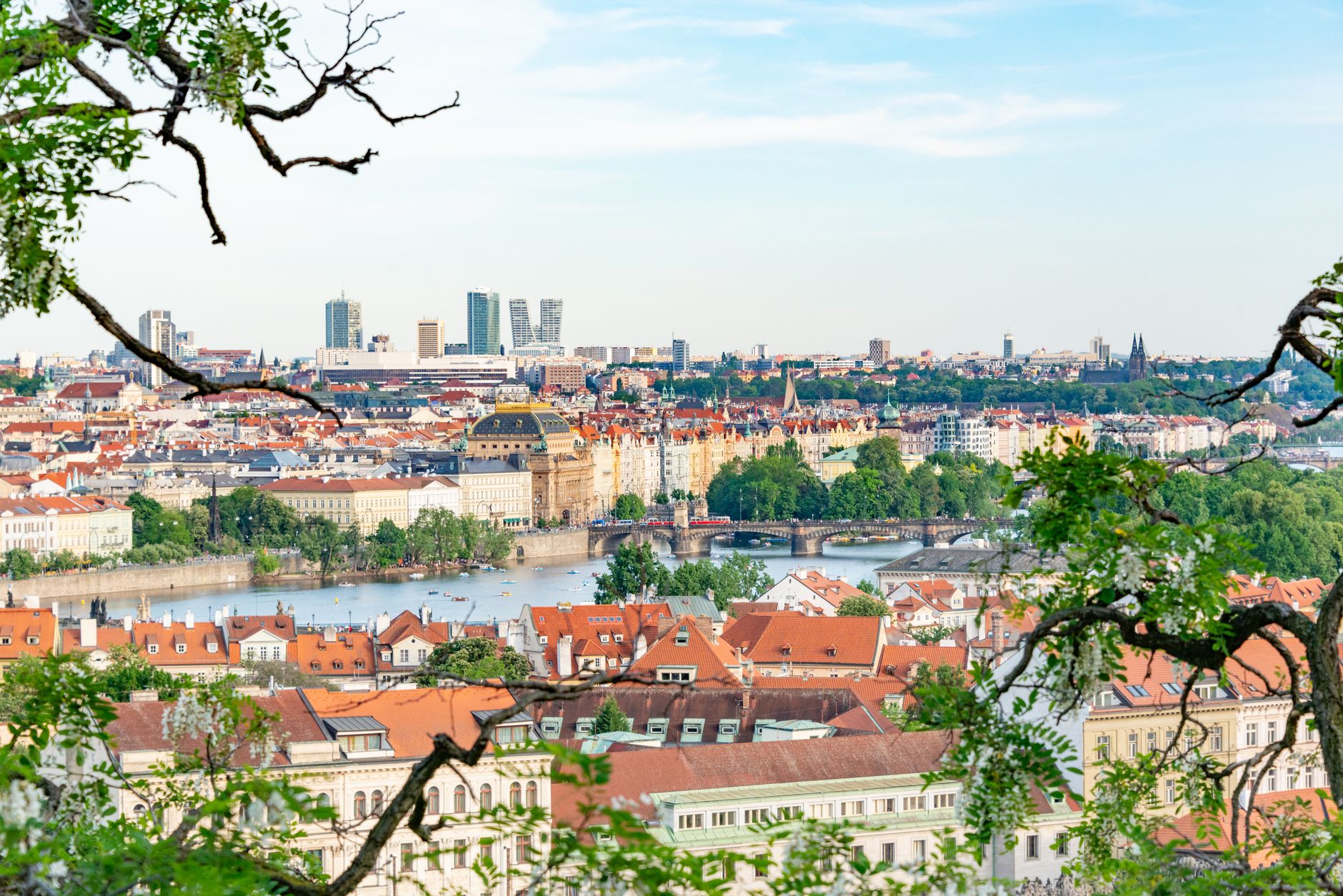 A beautiful aerial shot of Prague showcasing historic architecture and lush greenery along the Vltava River.
