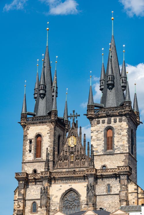 Free A stunning view of a Gothic church with intricate spires under a clear blue sky. Stock Photo