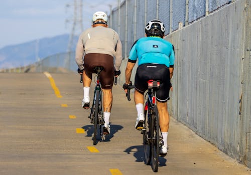 Back View of Cyclists on the Street in City 