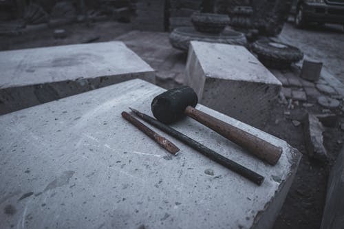 Hammer and Tools on Stone Block