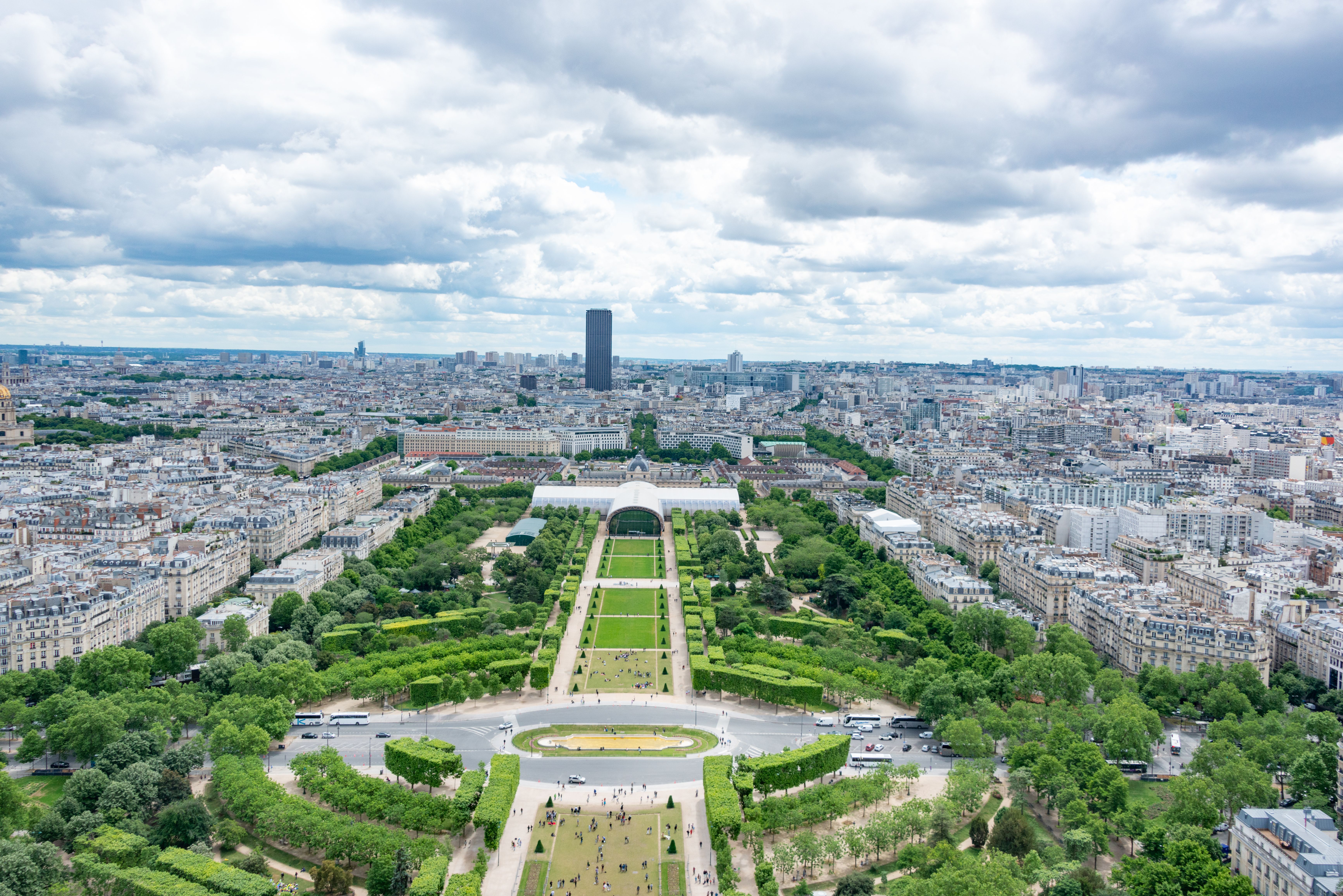 Aerial shot of Champ de Mars with panoramic view of Paris under cloudy skies. Aerial shot of Champ de Mars with panoramic view of Paris under cloudy skies.