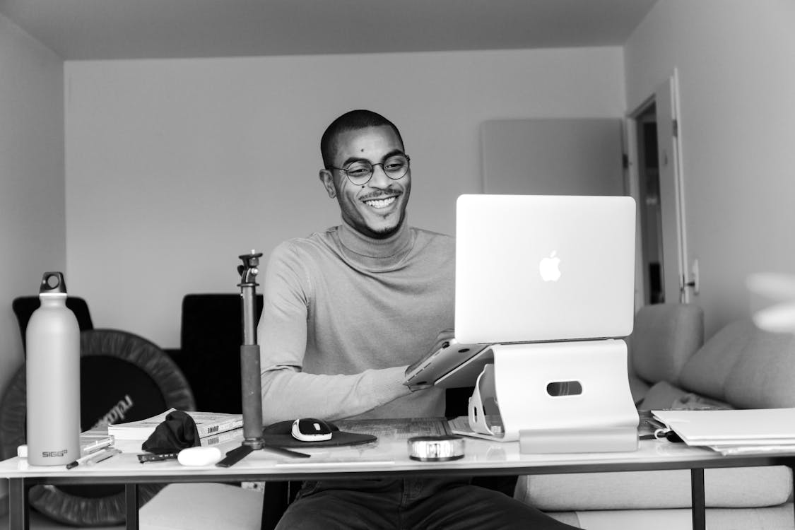 Smiling Man Working on Laptop