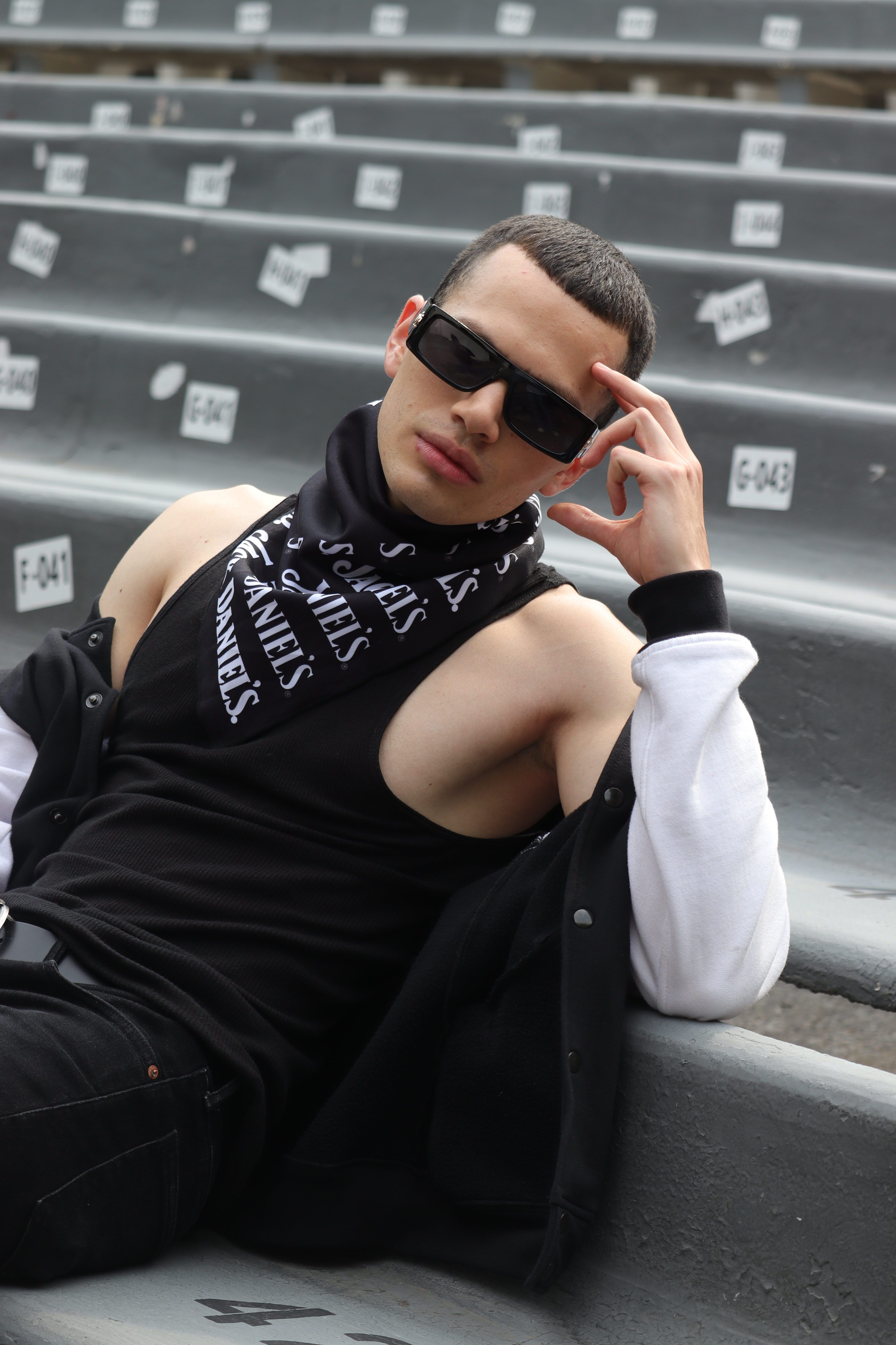 Stylish young man posing on benches in Ciudad de México. Fashion and attitude meet in this urban portrait.