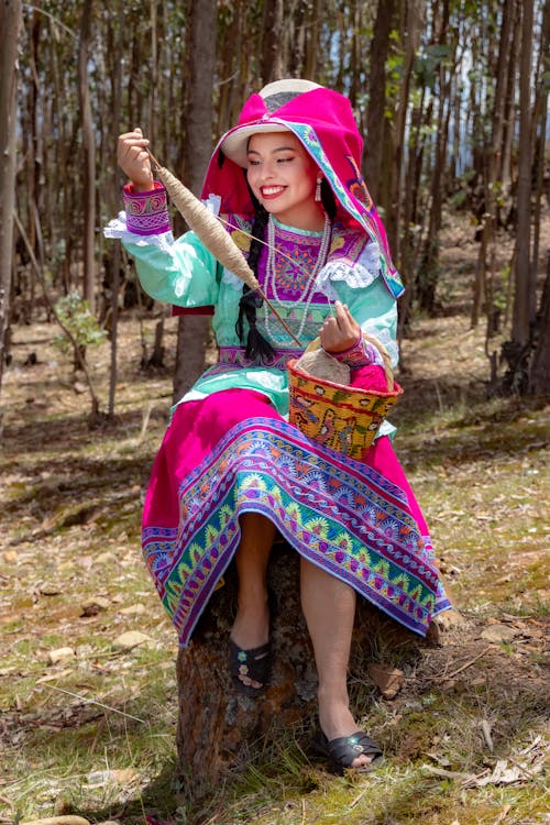 Smiling Woman Posing in Traditional Clothing in Forest