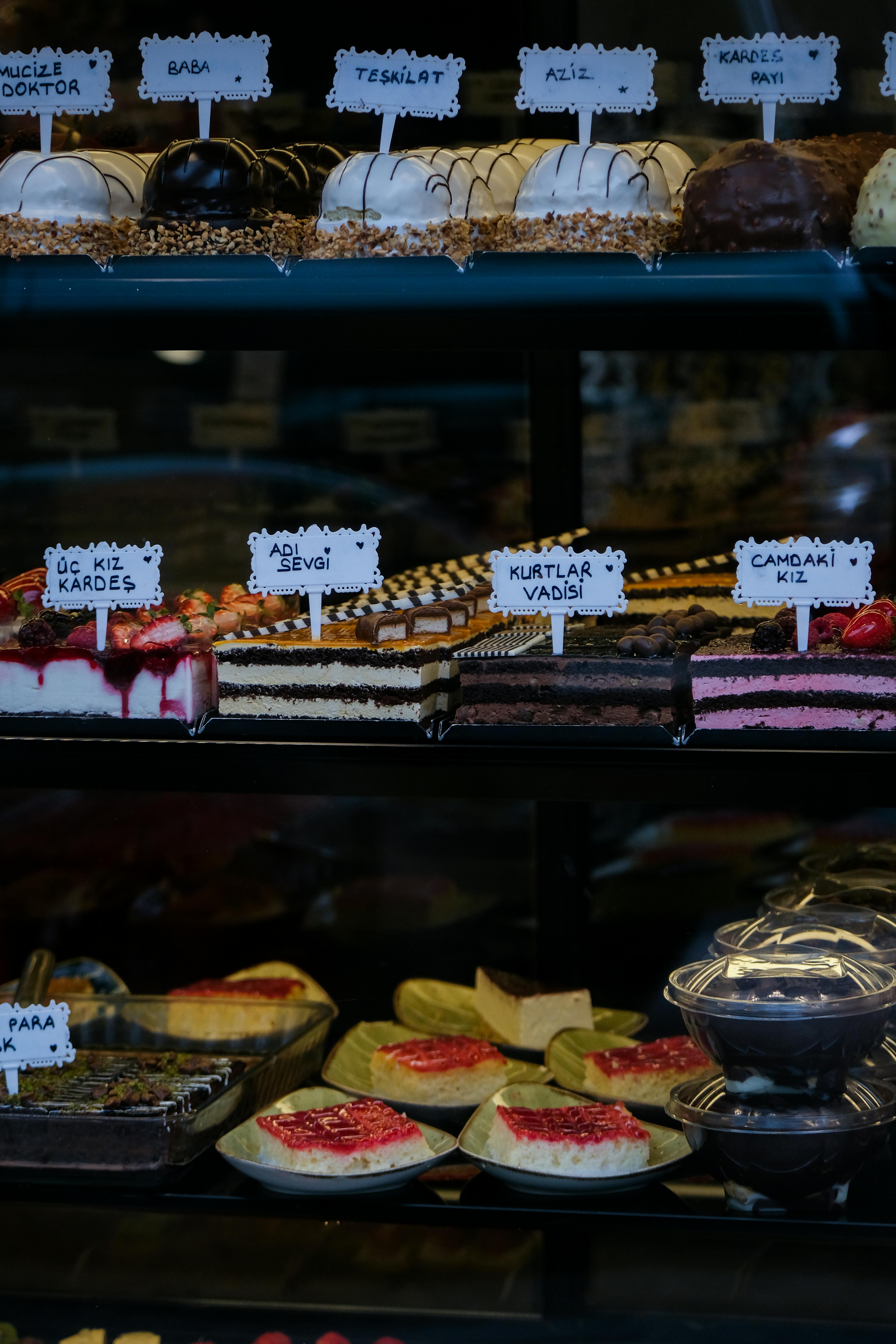 Delicious assortment of cakes and pastries on display in a patisserie. Ideal for food lovers.