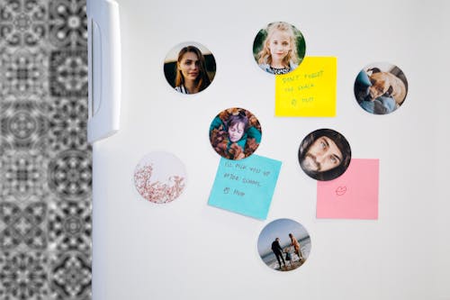 photo magnets with notes on a fridge