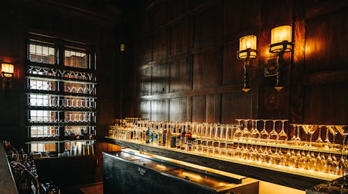 Glassware and Alcohol Bottles on the Counter at the Bar 