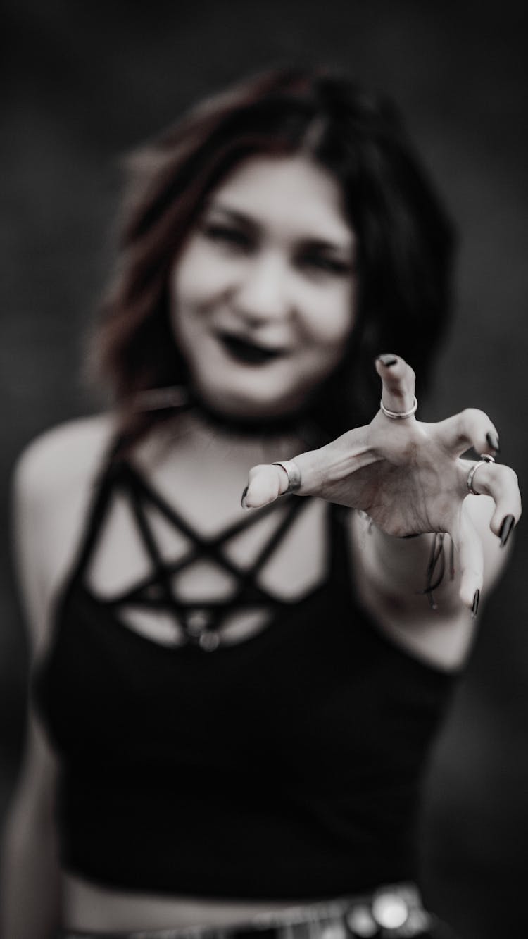 Woman Reaching Out Her Hand Towards The Camera