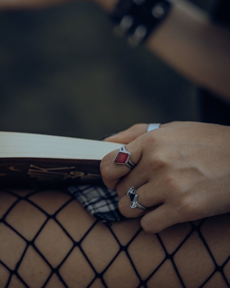 Woman Hand Holding Opened Book