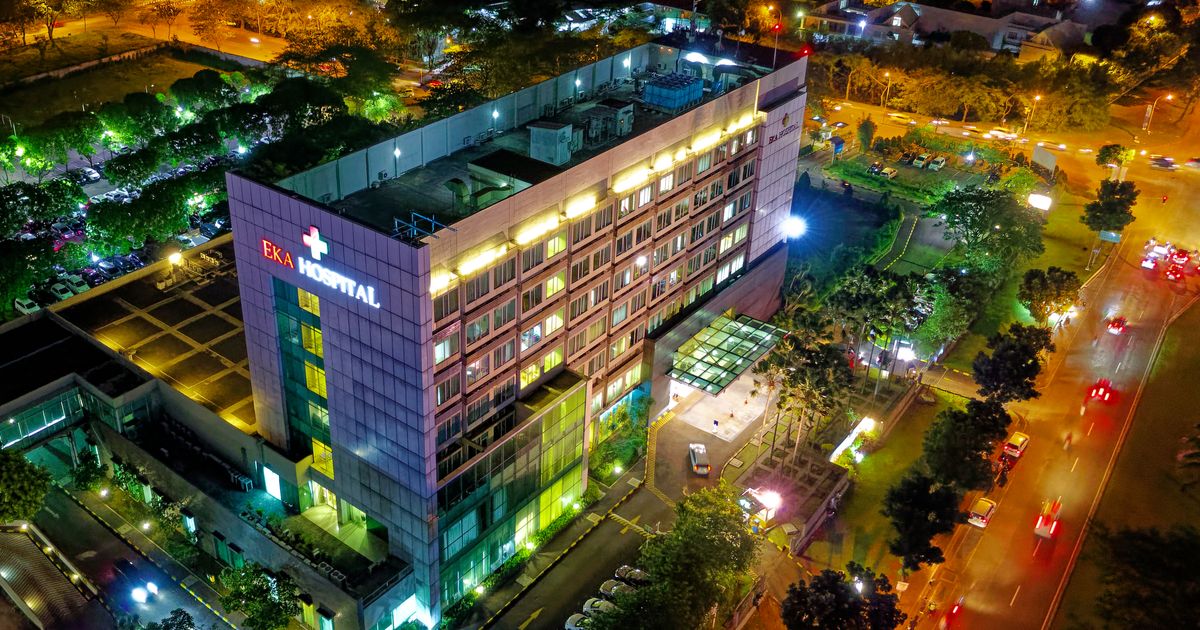 Hospital building illuminated at night, urban architecture