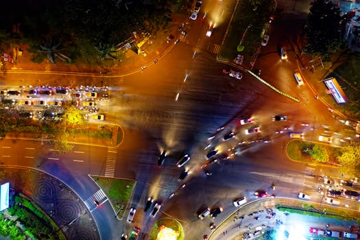 Dynamic aerial night shot of a bustling intersection in Serpong, Indonesia.