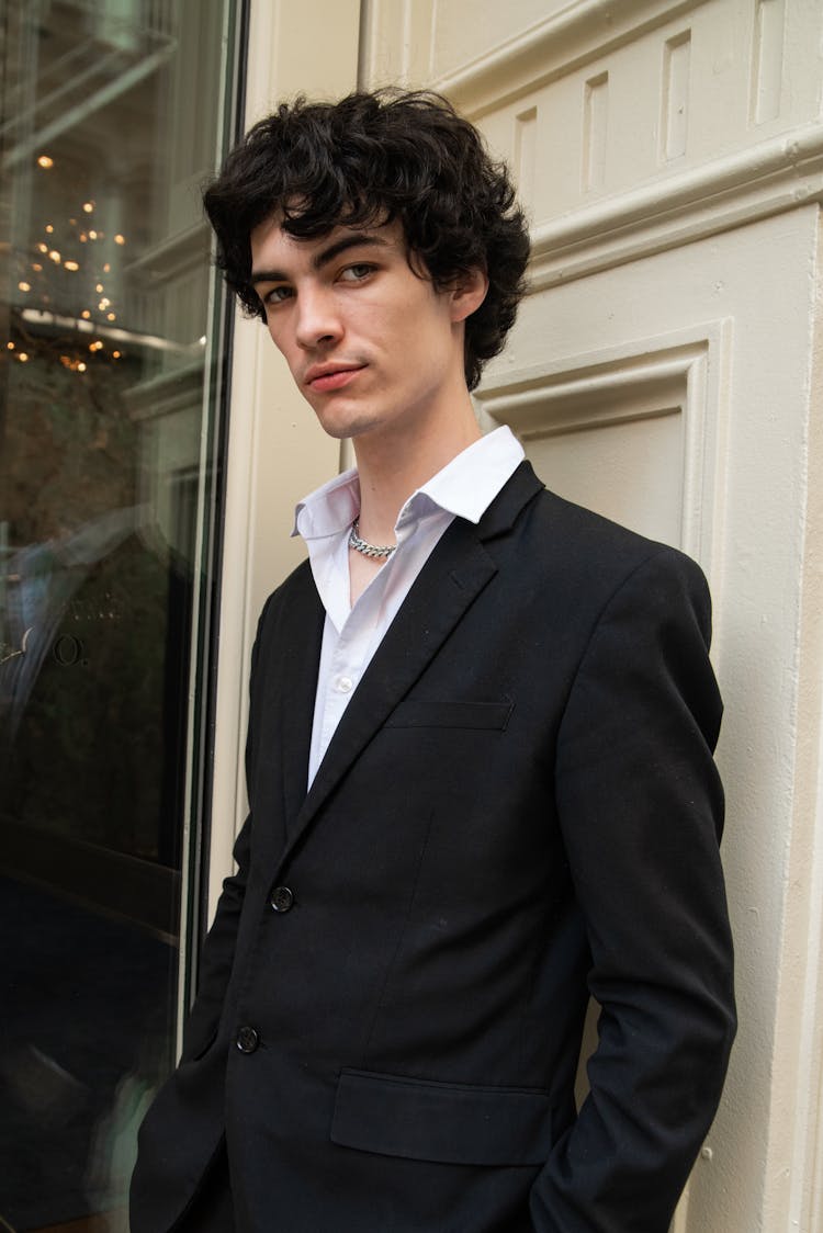 Man Posing In Black Suit And White Shirt