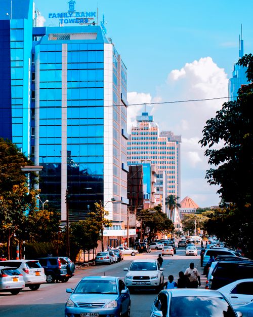 Free Dynamic cityscape showcasing modern skyscrapers and bustling urban life on a sunny day. Stock Photo