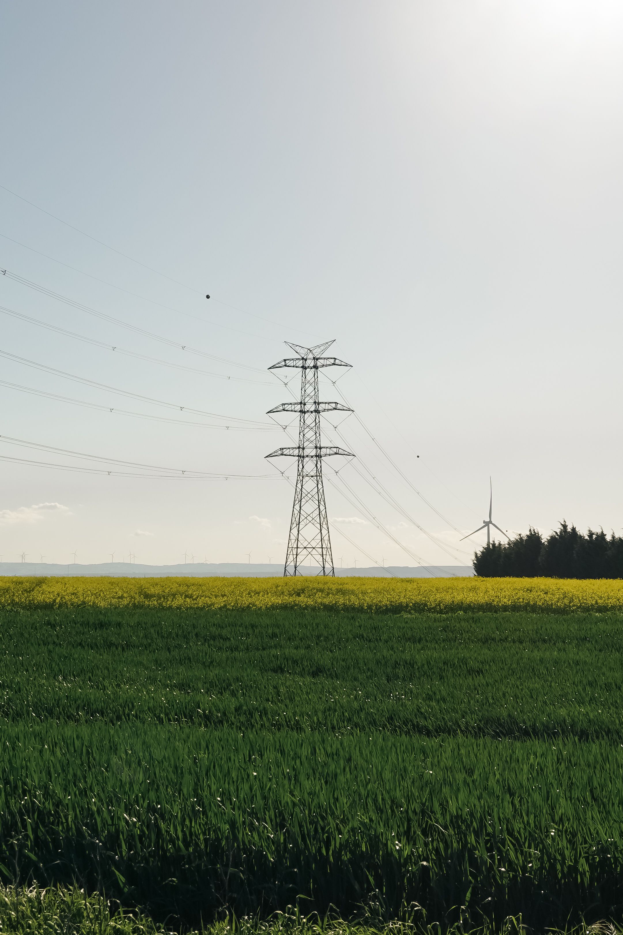 Transmission towers crossing open paddocks, the kind of long-lived infrastructure super funds are meant to finance