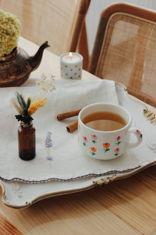 Tea in Cup and Herbs on Tray on Table