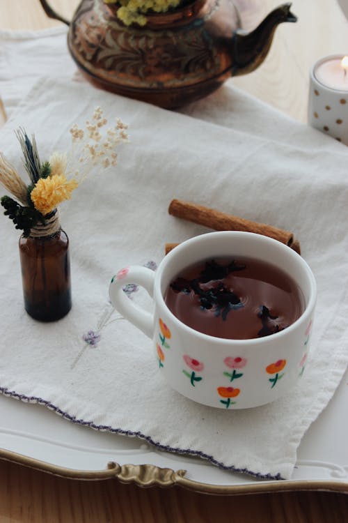 Flowers and Cinnamon near Tea Cup