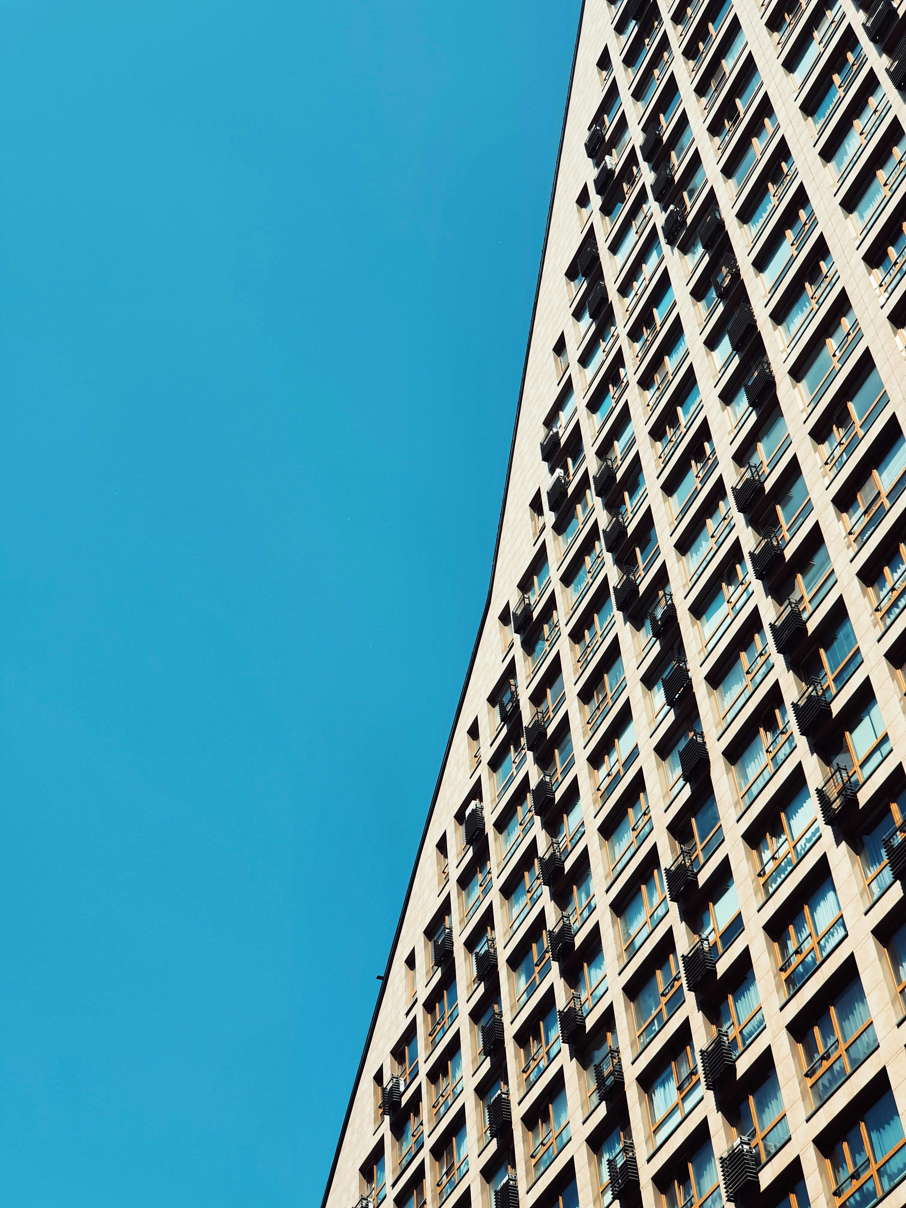 An impressive skyscraper in Kyiv with glass windows and a clear blue sky, capturing modern architecture.