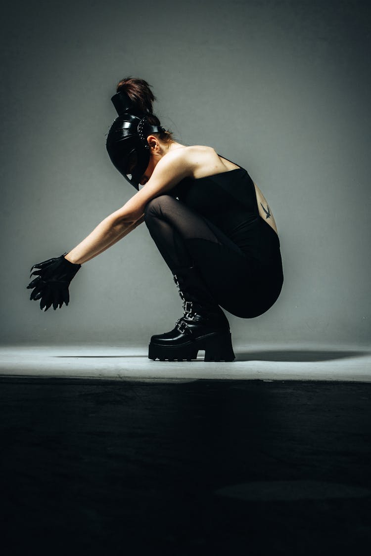 Woman In Mask Posing In Grey Studio