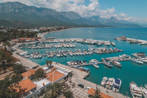 Free Stunning aerial view of Kemer marina with yachts and mountains in Antalya, Türkiye. Stock Photo