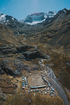 Explore the vibrant atmosphere of a cultural gathering in a scenic Peruvian valley.