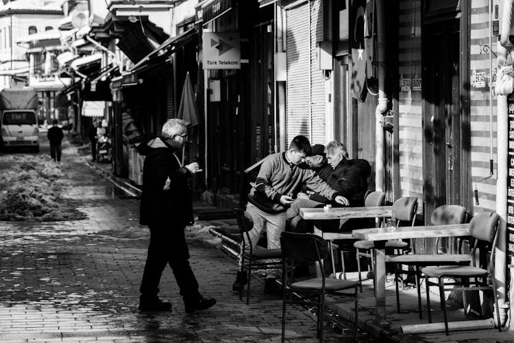 People In Alley In Town In Black And White