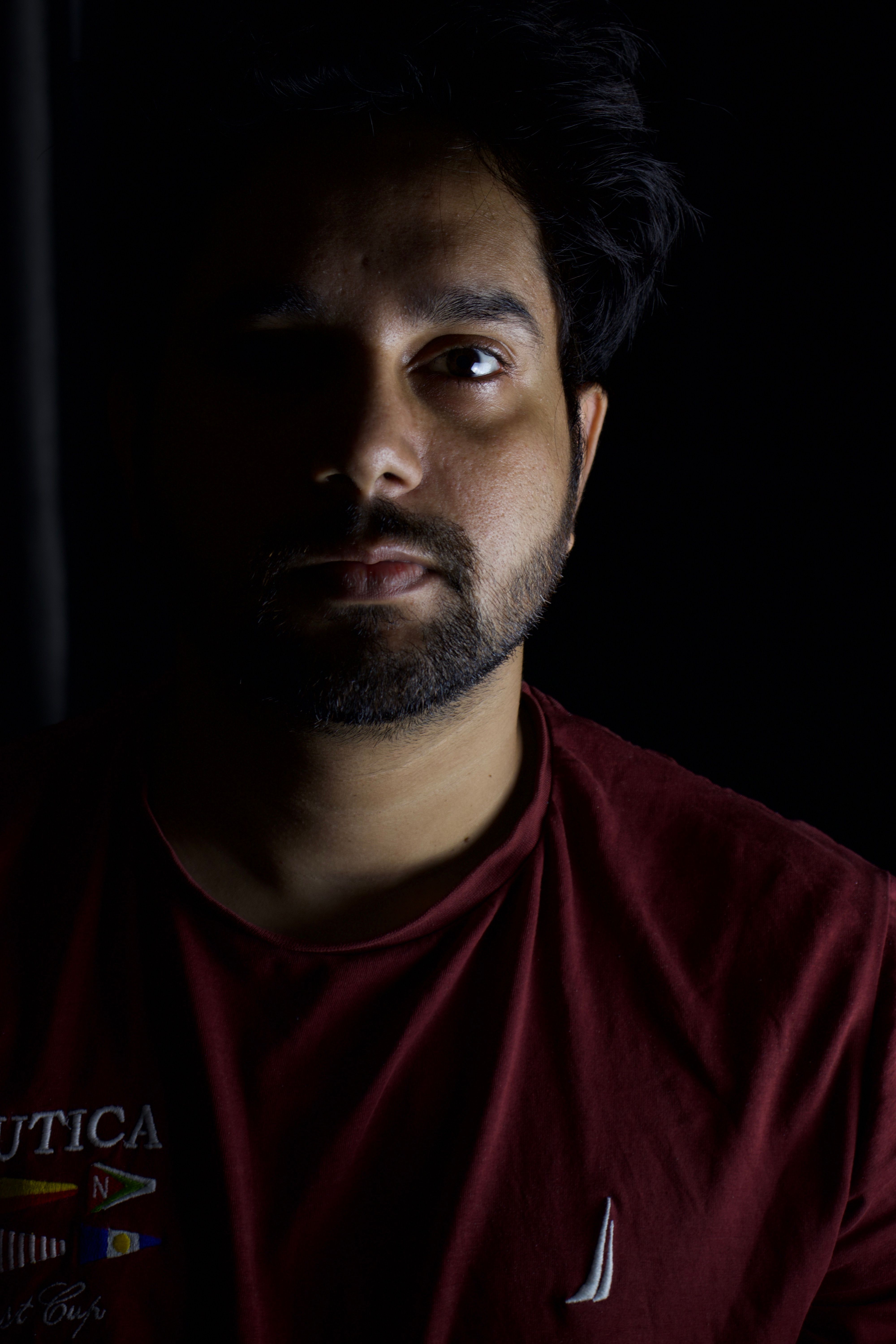 Portrait of a man with dramatic side lighting, creating a mysterious and introspective mood.. portrait, with, dramatic