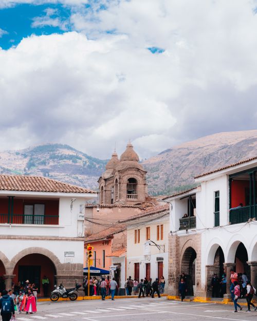 Free Vibrant scene of Ayacucho's old town with mountains and pedestrians. Stock Photo