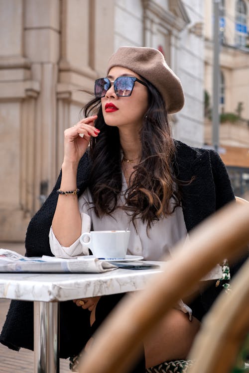 Elegant Woman Sitting at the Table in a Cafe