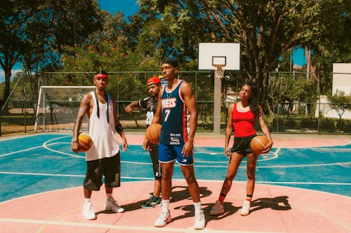 A Group of Young People at the Basketball Court Outdoors in Summer 