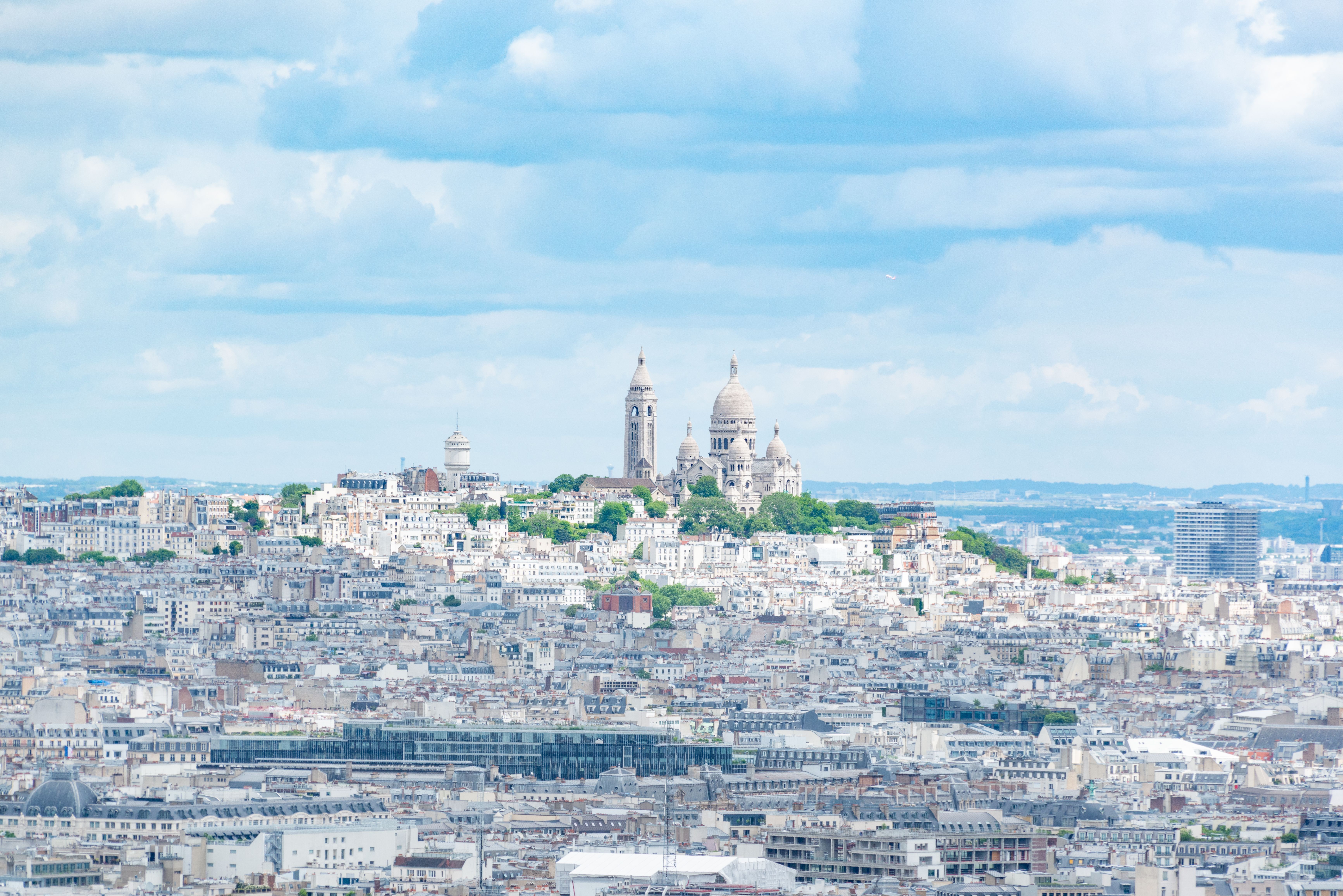 Experience a stunning aerial view of Montmartre and Sacré-Cœur in Paris, showcasing the city's architectural beauty. Experience a stunning aerial view of Montmartre and Sacré-Cœur in Paris, showcasing the city's architectural beauty.