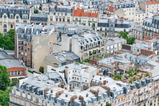 Charming aerial capture of Paris rooftops showcasing classic French architecture in summer.