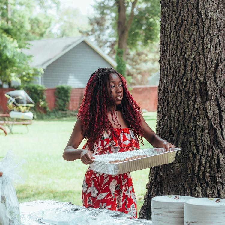 Woman Bringing Food On Garden Party