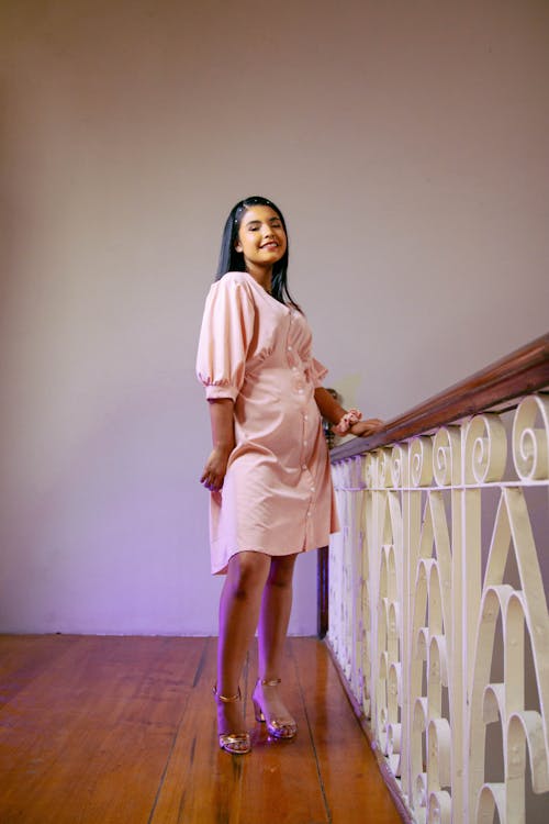 Young Woman Posing in a Pink Dress